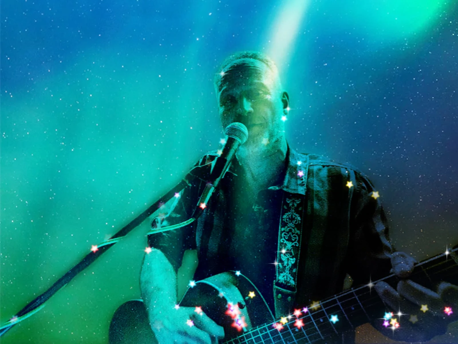 Michael Stern unplugged mit Akustikgitarre im Bühnenlicht